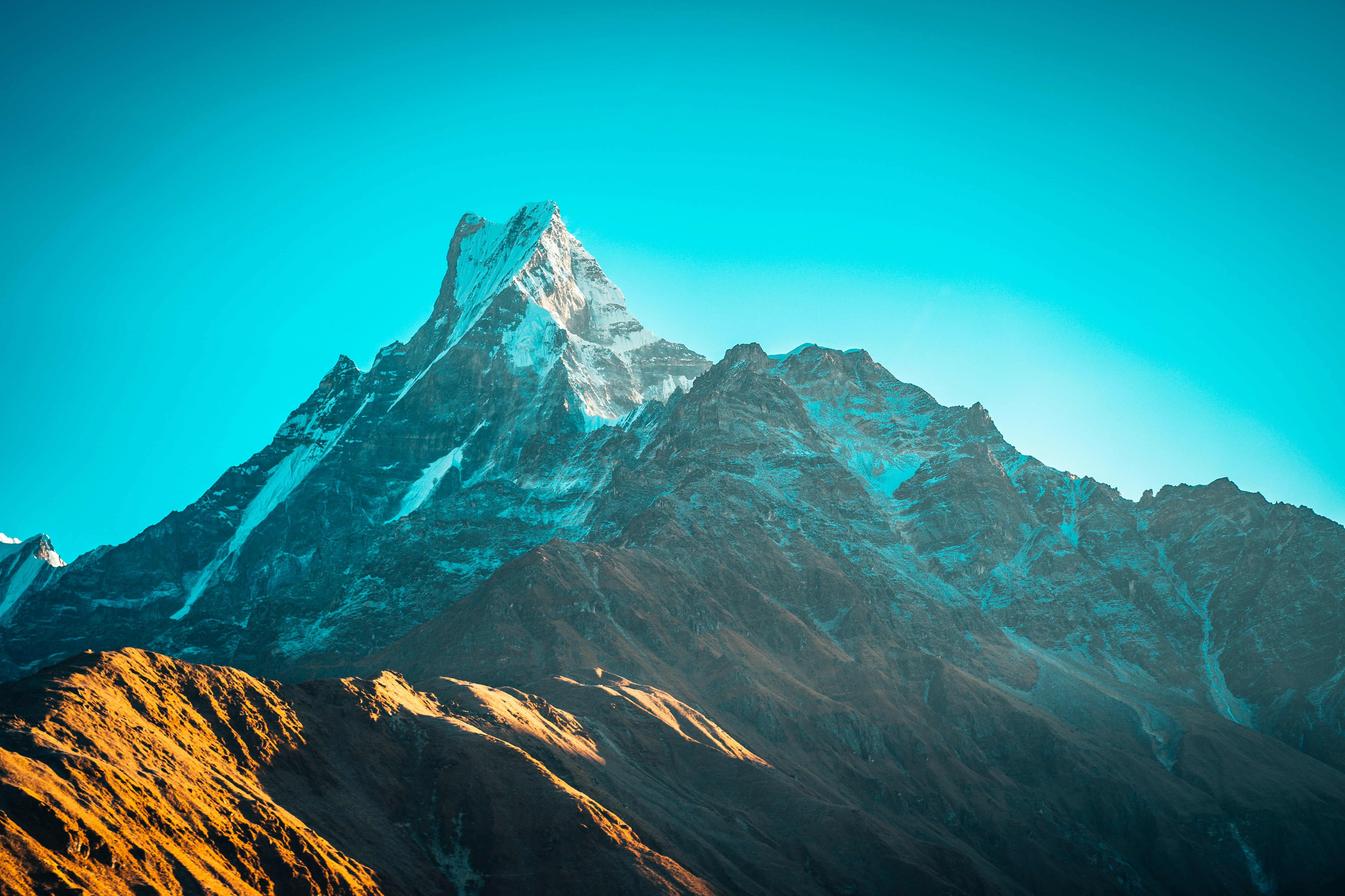 gray rocky mountain under blue sky during daytime